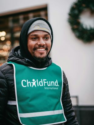 Smiling volunteer for ChildFund International in winter attire, San Luis Obispo.
